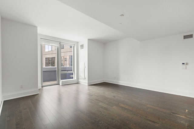 unfurnished room with dark hardwood / wood-style flooring