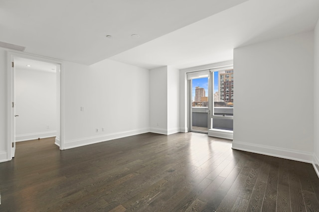 unfurnished room featuring dark hardwood / wood-style flooring