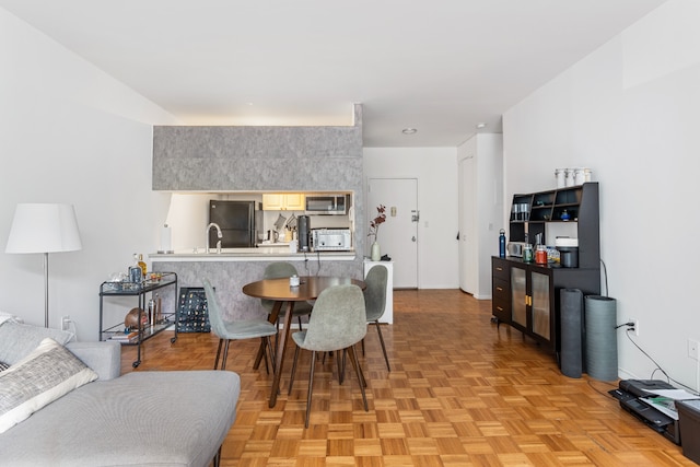 dining room with light parquet flooring and sink