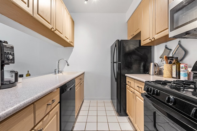 kitchen with black appliances, sink, light brown cabinetry, and light tile patterned floors