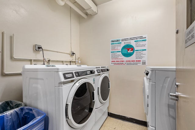 clothes washing area with separate washer and dryer