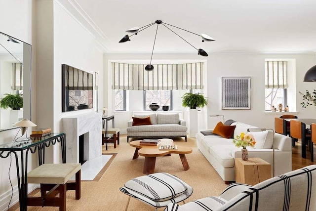 carpeted living room with ornamental molding, a high end fireplace, and a wealth of natural light