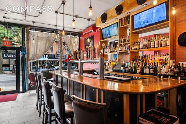 bar with an AC wall unit, brick wall, and wood counters