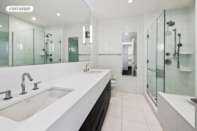 bathroom featuring vanity, tile walls, toilet, and an enclosed shower