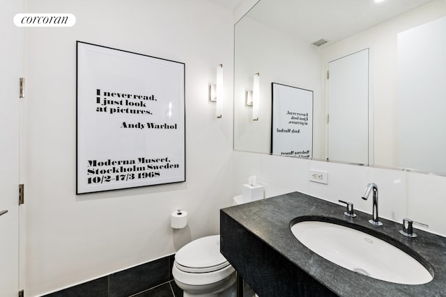 bathroom featuring vanity, tile patterned flooring, and toilet