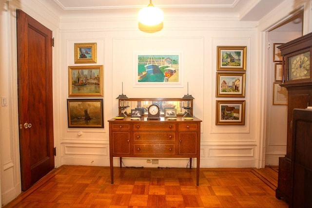 hall featuring dark parquet floors and ornamental molding