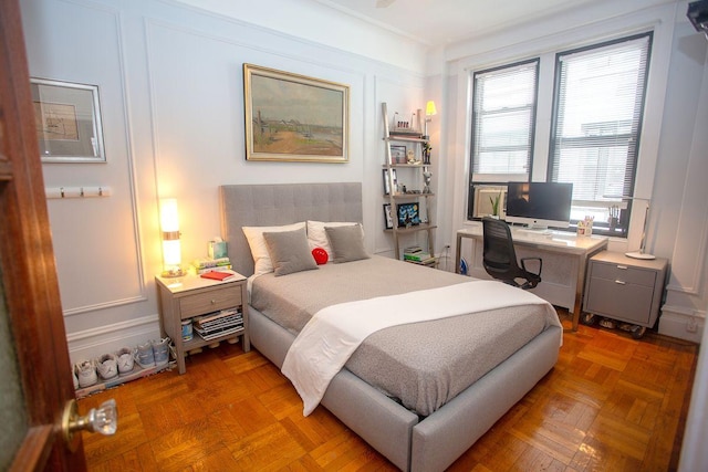 bedroom featuring parquet flooring and ornamental molding