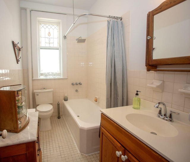 full bathroom featuring tile patterned floors, vanity, tile walls, and toilet