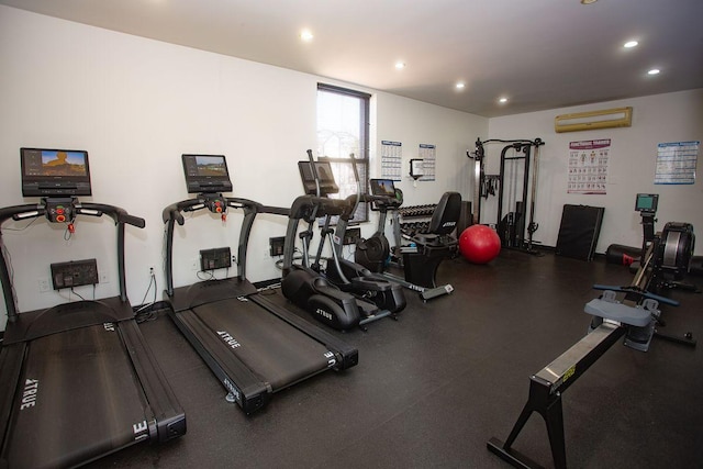 gym featuring a wall unit AC