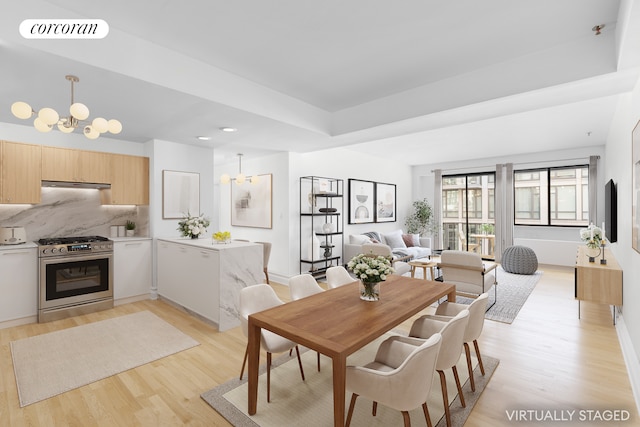 dining area featuring an inviting chandelier and light hardwood / wood-style floors