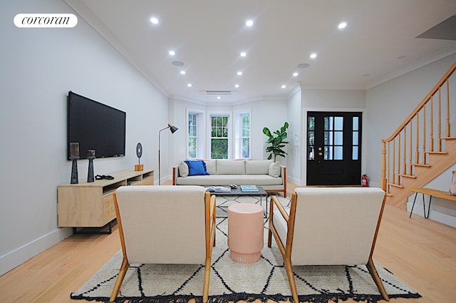 living room featuring ornamental molding and light hardwood / wood-style floors