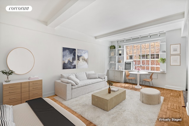 living room with beam ceiling, track lighting, and parquet floors