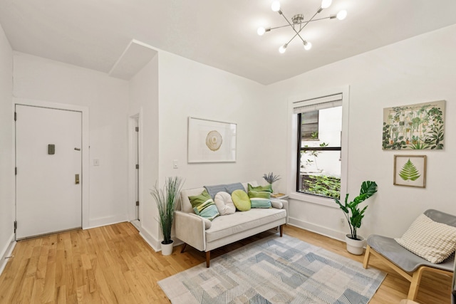 living area featuring light hardwood / wood-style flooring and a chandelier