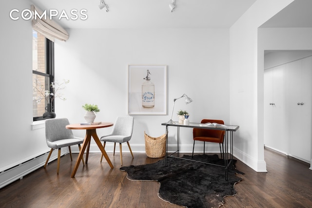 sitting room with rail lighting and dark hardwood / wood-style floors