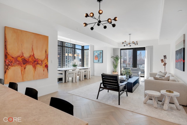 living room with light parquet floors and a notable chandelier