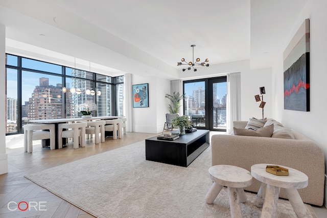 living room with light parquet flooring and a chandelier