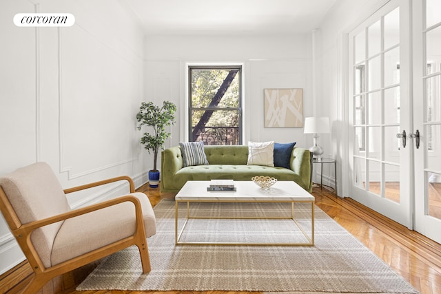 living area featuring parquet flooring and french doors