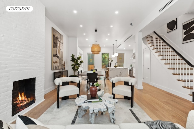 living room featuring a fireplace and light hardwood / wood-style flooring