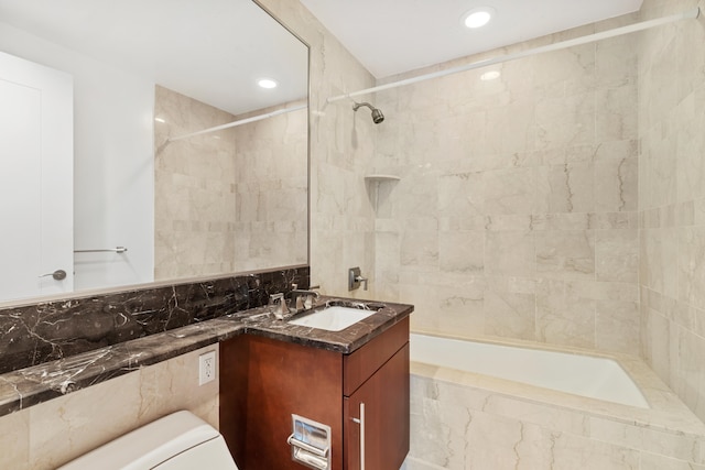 full bathroom featuring vanity, toilet, and tiled shower / bath