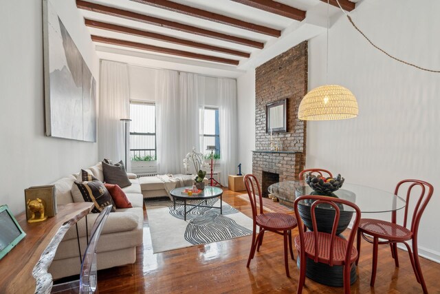 living room featuring dark hardwood / wood-style floors, a fireplace, and beam ceiling