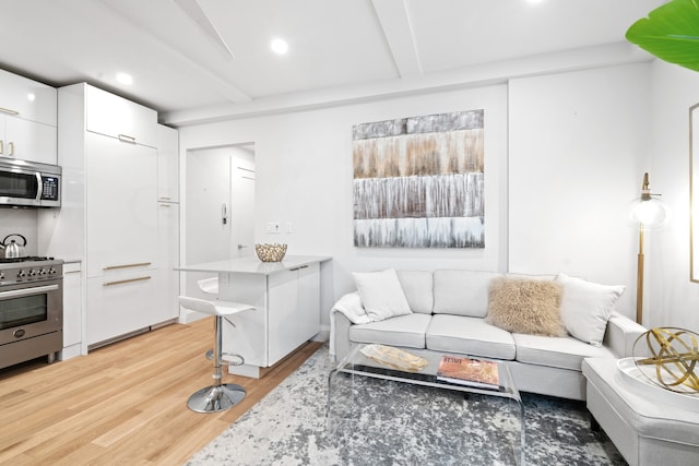 living room featuring light wood-type flooring and beam ceiling