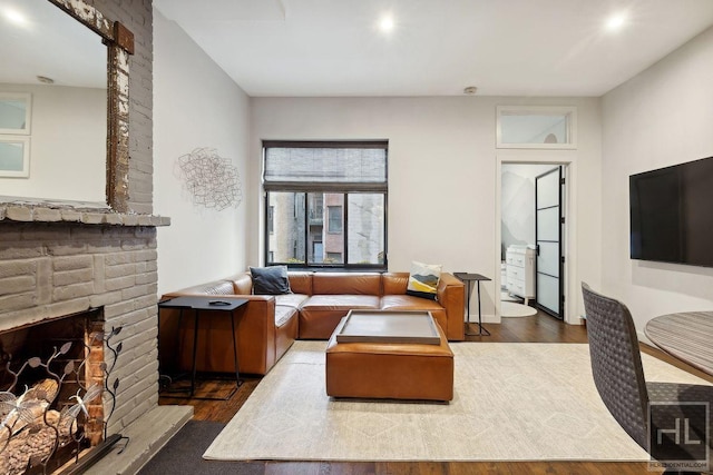 living room with a fireplace and dark hardwood / wood-style floors