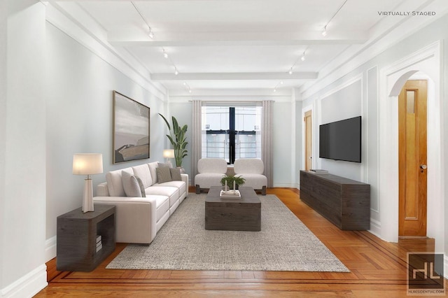 living room featuring light parquet floors, beamed ceiling, and track lighting