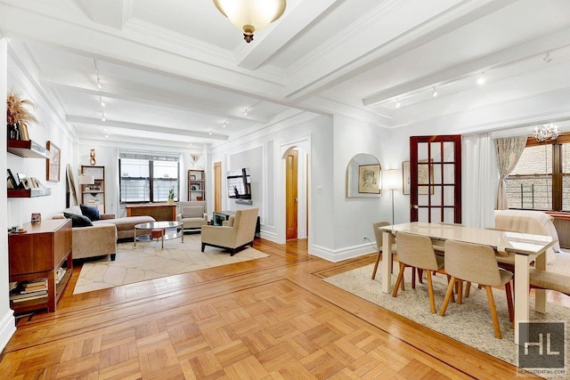 dining room featuring beam ceiling, crown molding, a chandelier, track lighting, and light parquet flooring