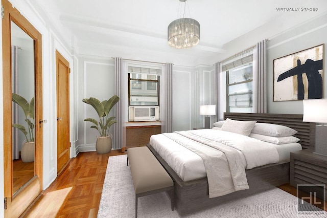 bedroom featuring cooling unit, light parquet flooring, and a notable chandelier