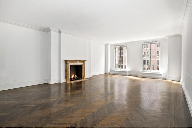 unfurnished living room with dark parquet flooring, crown molding, and a high end fireplace