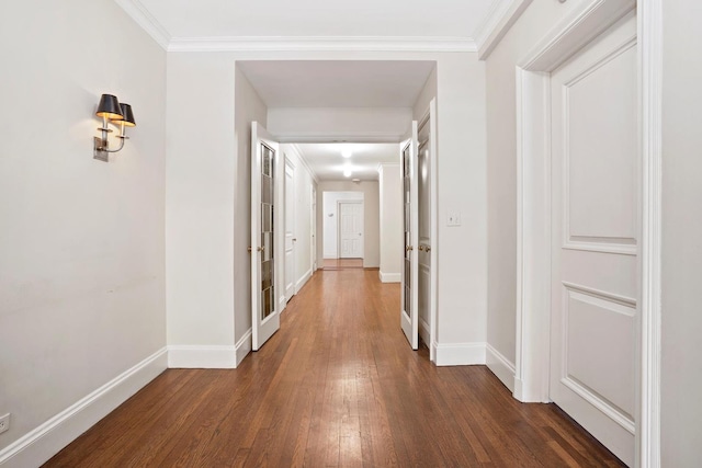 hall featuring ornamental molding and dark wood-type flooring