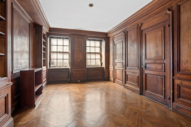 interior space featuring light parquet flooring and crown molding