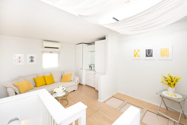 living room featuring light wood-type flooring and a wall mounted AC