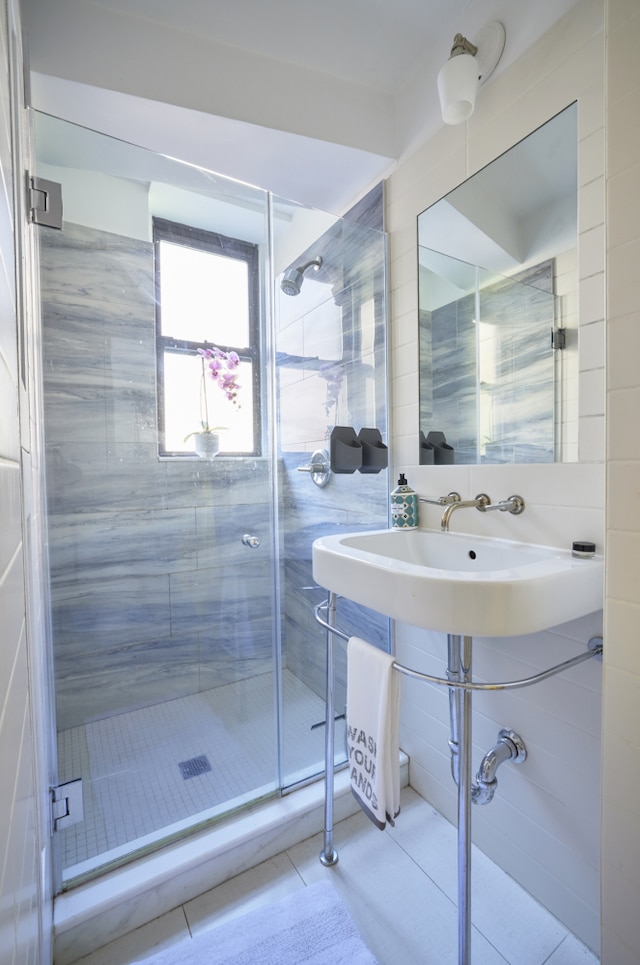 bathroom with tile patterned floors and a shower with shower door