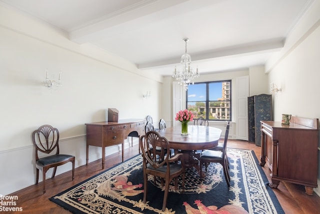 dining room featuring crown molding, dark wood-type flooring, a notable chandelier, and beam ceiling