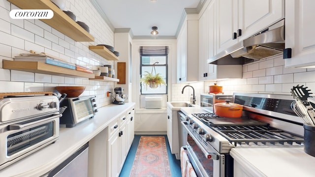 kitchen featuring tasteful backsplash, ornamental molding, sink, stainless steel stove, and white cabinetry