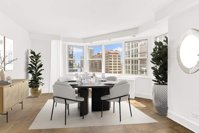 dining area featuring parquet flooring