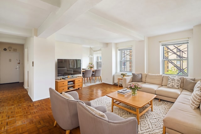 living room featuring beamed ceiling and dark parquet floors