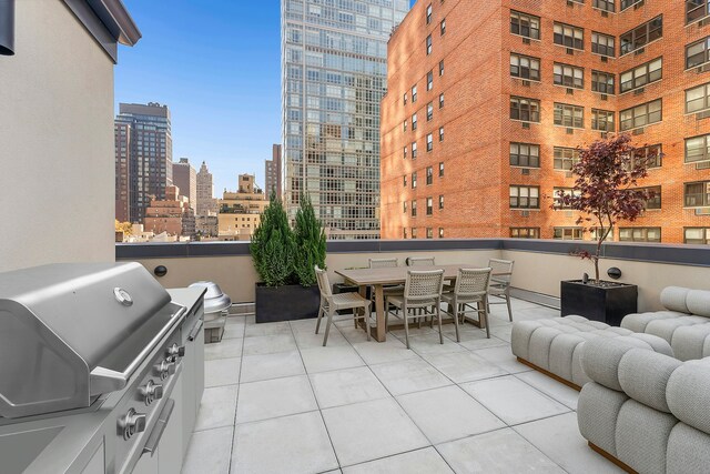 view of patio / terrace with area for grilling and a balcony