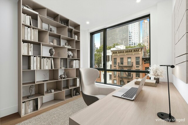 home office with light hardwood / wood-style floors