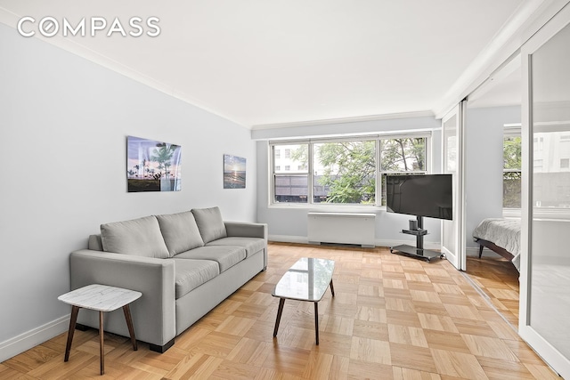 living room featuring ornamental molding and light parquet floors