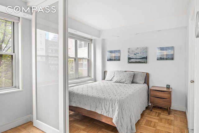 bedroom with light parquet flooring