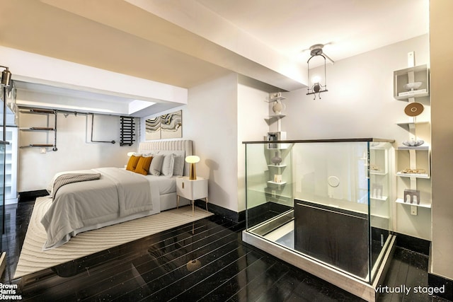 bedroom featuring dark hardwood / wood-style flooring