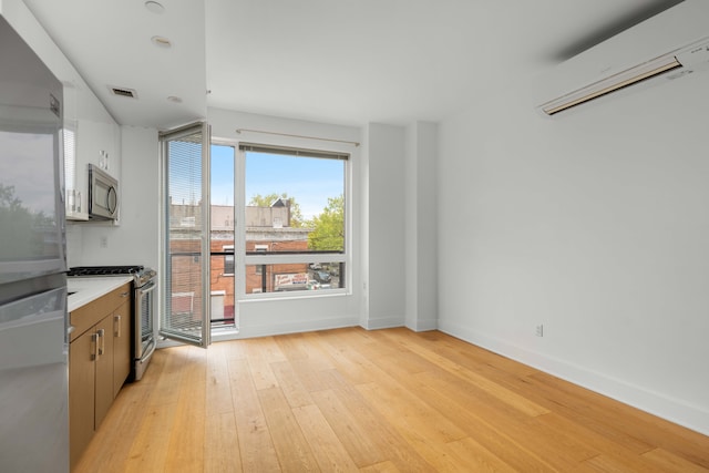 interior space featuring light hardwood / wood-style flooring and a wall unit AC