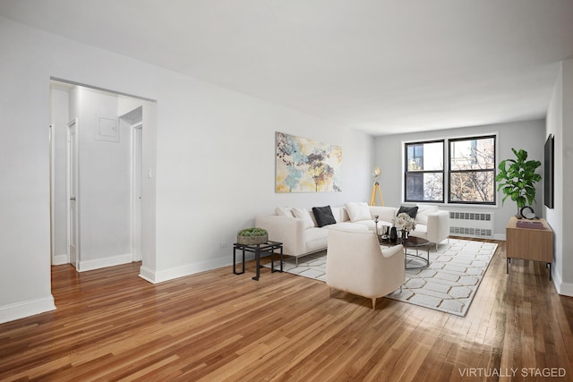 living room with hardwood / wood-style floors and radiator