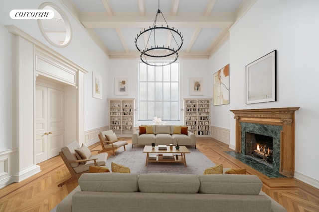 living room featuring beamed ceiling, a high end fireplace, and light parquet floors