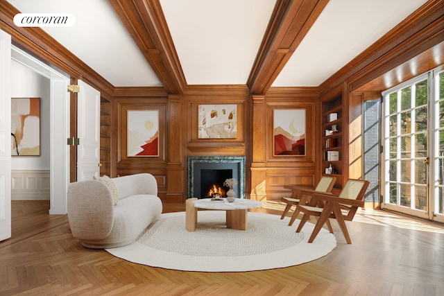 living room with crown molding, parquet flooring, and a premium fireplace