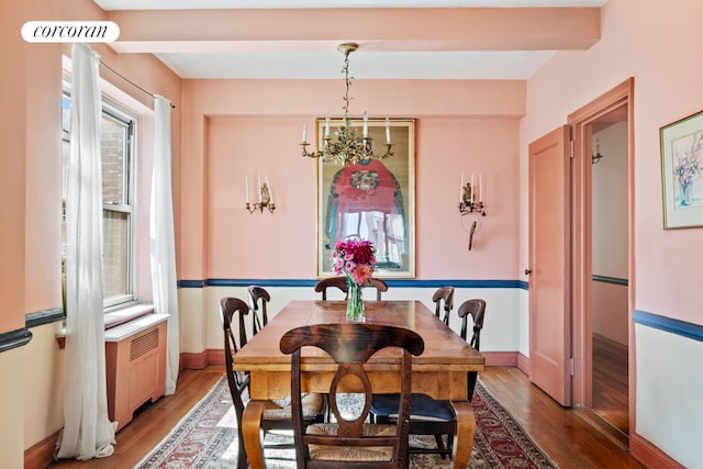 dining room with wood-type flooring, a notable chandelier, and beam ceiling