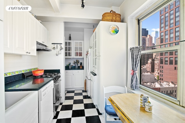 kitchen with white cabinets, beam ceiling, white appliances, and decorative backsplash