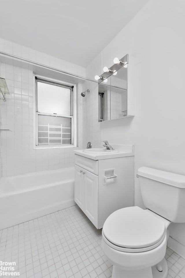 full bathroom with vanity, tiled shower / bath combo, toilet, and tile patterned floors